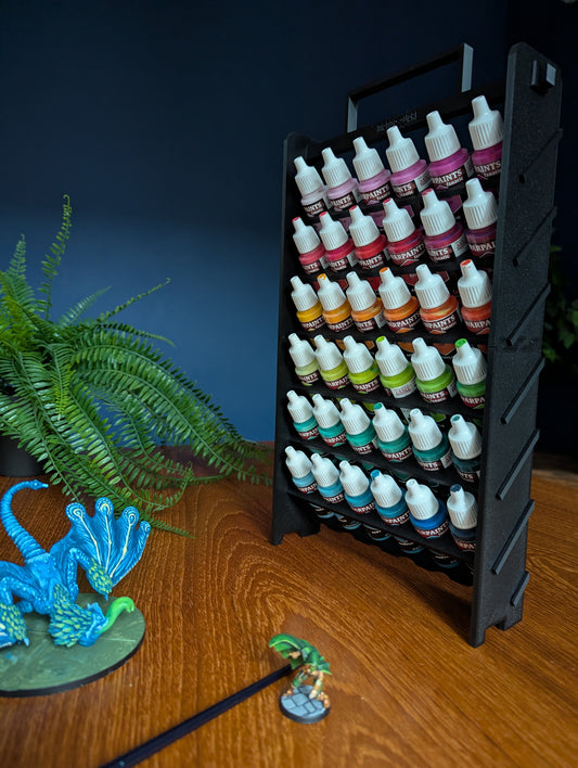 An image of the paint rack all built-up from the front with miniatures in front of it