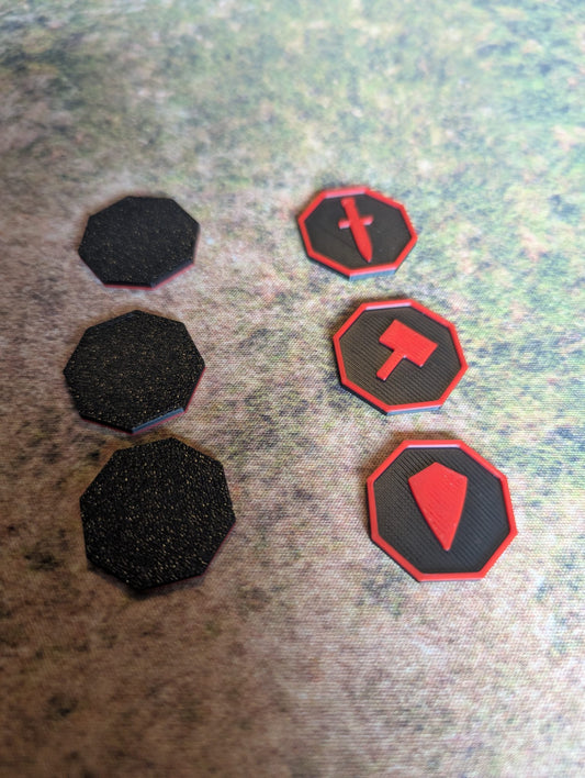Black and red octagonal game pieces on a textured surface