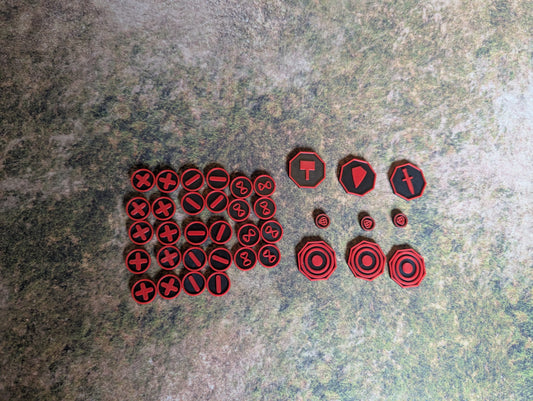 Set of red and black gaming dice with symbols on a textured surface